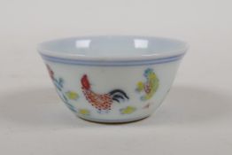A Ming style doucai porcelain tea bowl with chicken decoration, Chinese 6 character mark to base,