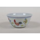 A Ming style doucai porcelain tea bowl with chicken decoration, Chinese 6 character mark to base,