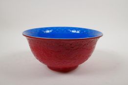 A Chinese red and blue glazed porcelain bowl with dragon decorated to the exterior and phoenix