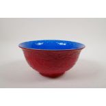 A Chinese red and blue glazed porcelain bowl with dragon decorated to the exterior and phoenix