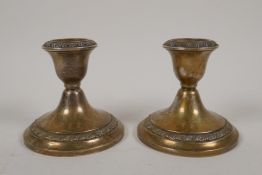 A pair of dwarf sterling silver candlesticks by Gorham Silver in Providence, Rhode Island, 3" high