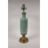 A brass and celadon glazed porcelain lamp, with underglaze floral decoration, 18" high