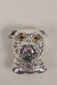 A silver pendant brooch formed as the head of a dog with glass eyes