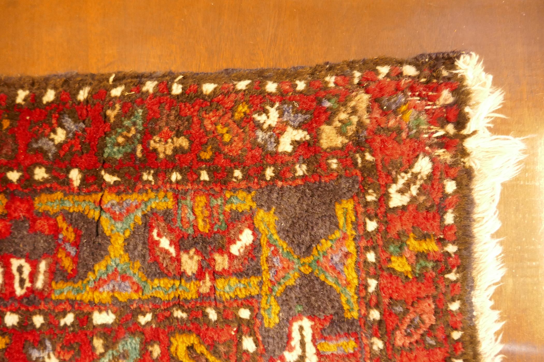 A thick pile red ground hand woven Persian Heriz runner with a cross medallion design, 42" x 138", - Image 6 of 7