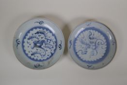 A pair of early C20th Chinese blue and white porcelain dishes with stylised hand painted dragon