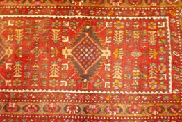A thick pile red ground hand woven Persian Heriz runner with a cross medallion design, 42" x 138",