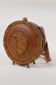 An Eastern European carved wood and brass mounted flask, with carved fruiting vine decoration and
