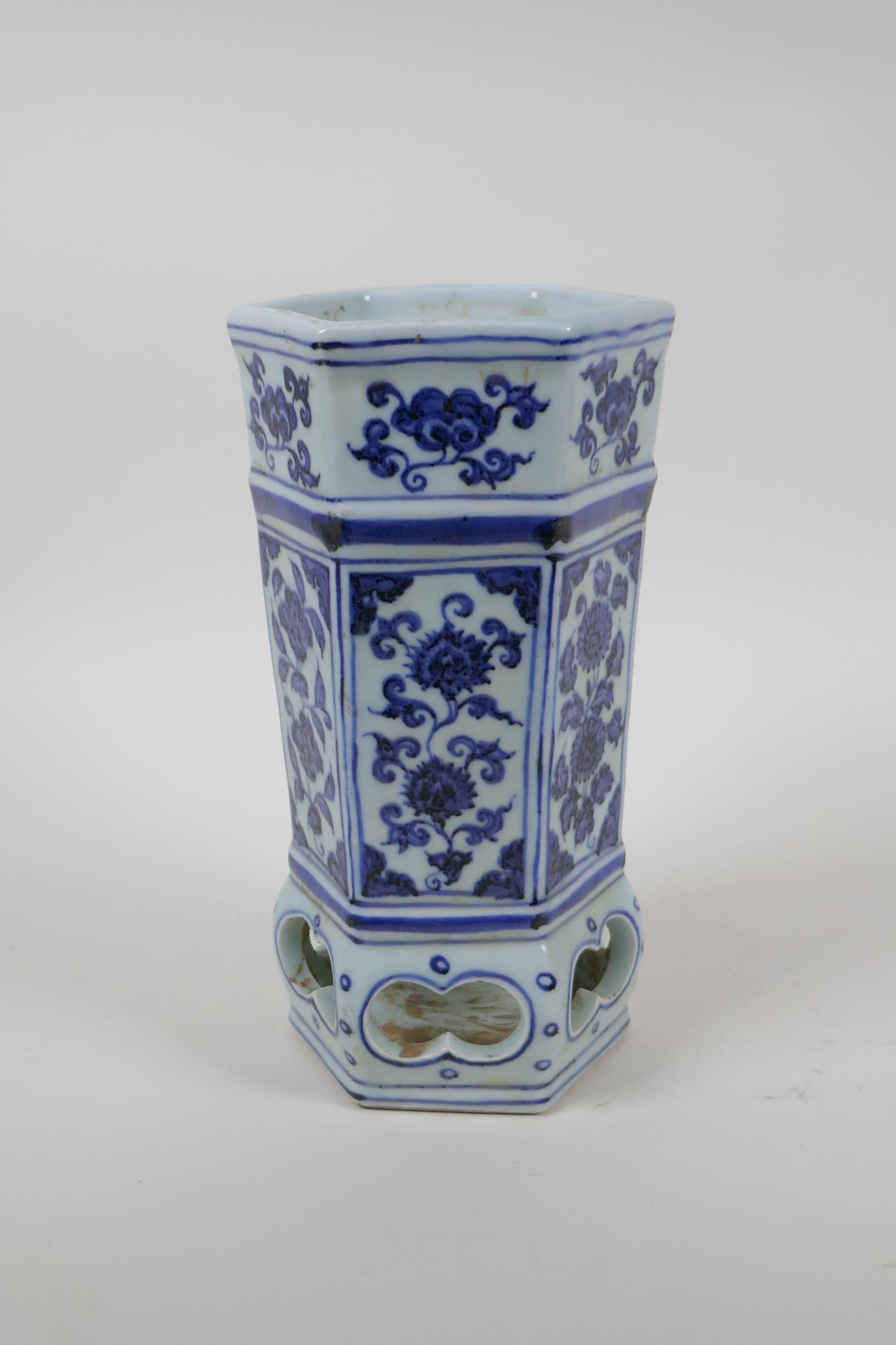 A porcelain brush pot with a pierced lower section and decorative floral panels, Chinese Xuande 6