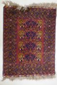 A burgundy ground wool rug with a geometric floral design, 54" x 41"