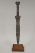 A Chinese bronze archaic style dagger, on a display stand, 14" long 14½" long
