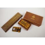 Two bridge card boxes containing cards and score sheets, a wooden bridge marker, a brass and wood