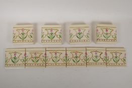 Eighteen cream ground hand painted tiles with floral pattern decoration, each tile 4¼" x 4¼"