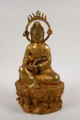 A Chinese gilt bronze figure of Quan Yin holding a ruyi, 12" high