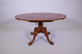 An oval top fruit wood coffee table on turned column and quadruple supports, 36" x 24", 19" high