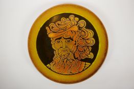 A Poole pottery 'Aegean' charger, hand painted by L.J. Wills, decorated with a portrait of a bearded