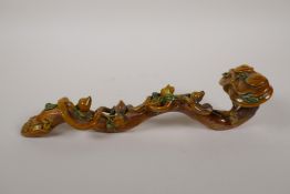 A Chinese Sancai glazed porcelain ruyi with applied peach tree and bat decoration, 12½" long