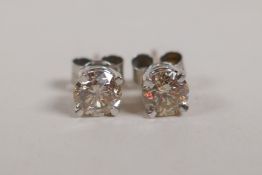 A pair of 14ct white gold and diamond stud earrings, approx 85 points