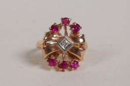 A 14ct rose gold lady's ring in the form of a bow, set with a diamond and rubies, size K