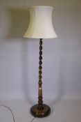 A faded mahogany barleytwist column standard lamp, 58" high, 71" to top of shade