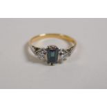An unmarked 18ct yellow gold Art Deco style ring set with a sapphire flanked by diamonds, size M