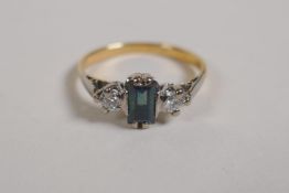 An unmarked 18ct yellow gold Art Deco style ring set with a sapphire flanked by diamonds, size M