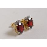 A pair of 10ct yellow gold, garnet and diamond set earrings