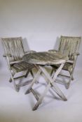 A Chilworth Collection weathered teak garden table and two folding chairs