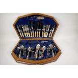 An Art Deco walnut cased canteen of silver plated cutlery, 22" wide