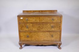 A 1920s figured walnut dressing chest of three long drawers, raised on cabriole supports, 36" x