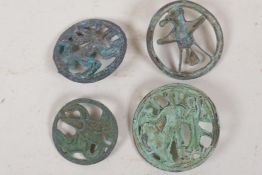 Five Islamic metal toggles with pierced animal decoration, largest 2" diameter