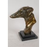 A stylised bronze bust of a greyhound on a stepped marble base, 8½" high