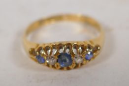 An 18ct gold set sapphire and aquamarine dress ring, size O, 2.6g gross