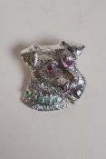 A sterling silver brooch in the form of a terrier's head, with ruby set eyes and an emerald set