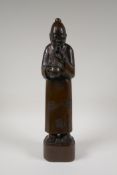 A Chinese carved hardwood figure drinking tea, 16" high
