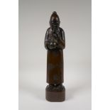 A Chinese carved hardwood figure drinking tea, 16" high