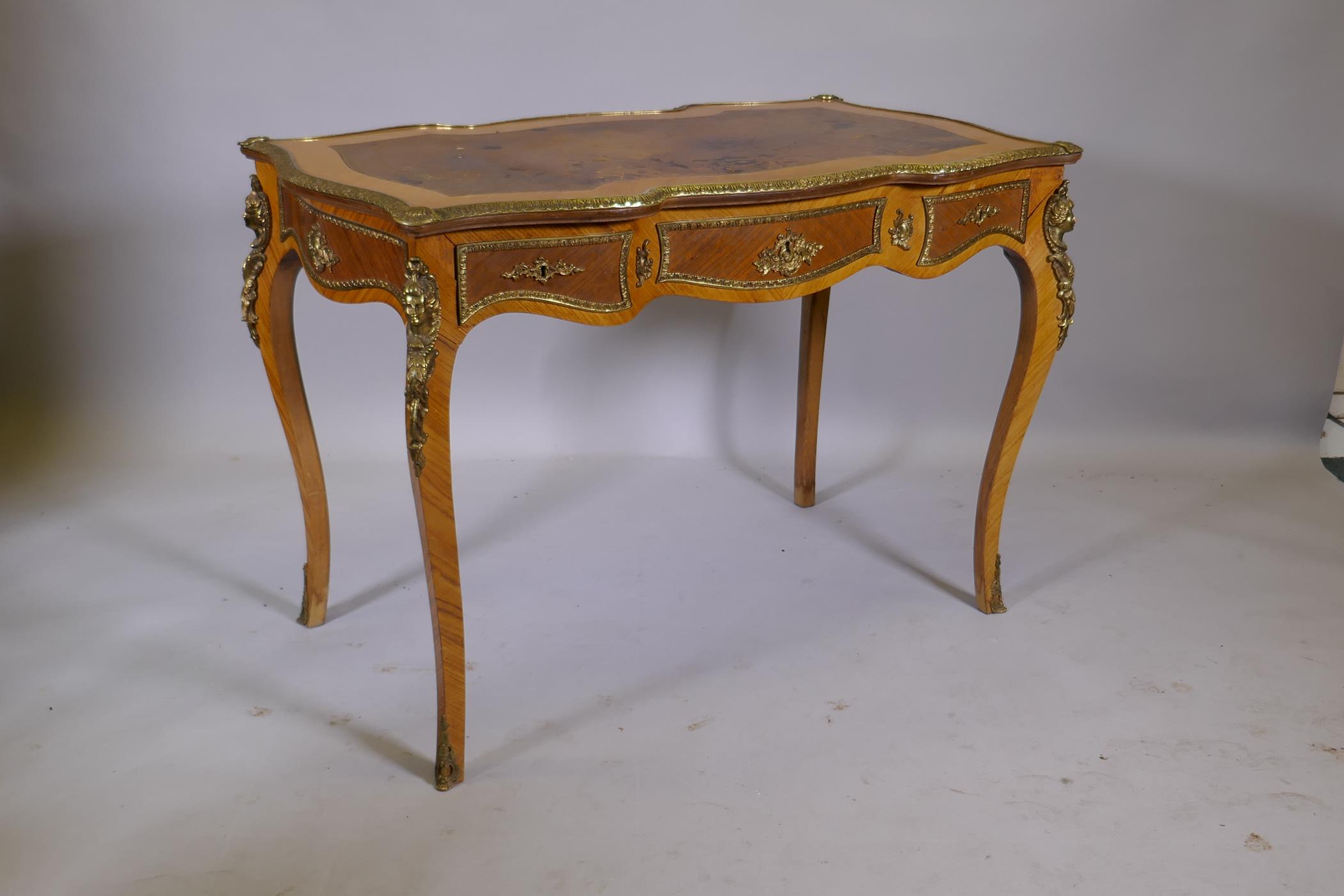 A Louis XV style inlaid tulipwood and brass mounted writing table, with inset leather top and three - Image 9 of 9