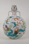 A Chinese Ming style Fahua porcelain moon flask with two handles, and dragon decoration in the