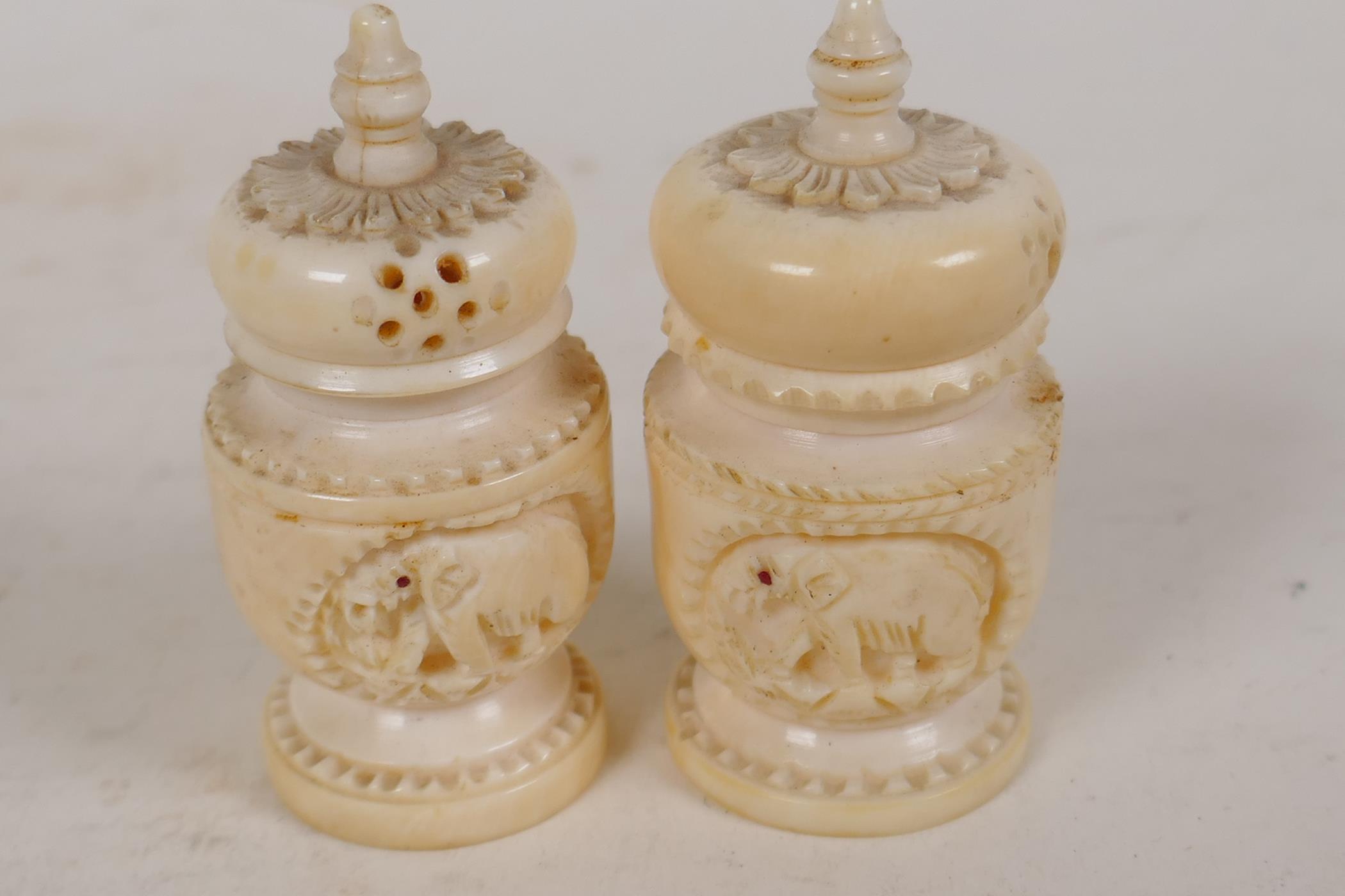 An Indian ivory cruet carved as temple towers, 2" high, and a similar smaller cruet - Image 2 of 4