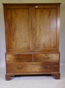 A George III mahogany linen press of small proportions, the doors and drawers with crossbanded inlay