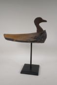A naive carved wood decoy duck on a display stand, 18½" high
