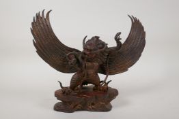 A Tibetan gilt bronze figure of Garuda, 9½" high x 12" wide