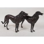 A pair of bronze figures of hounds, 6½" long