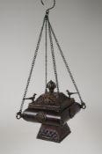 A Tibetan bronzed metal hanging censer and cover, decorated with birds, vajra and tantric emblems,