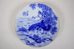 A Chinese blue and white porcelain cabinet plate decorated with cockerels on a riverbank,