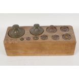 A set of C19th brass weights, 10g - 2kg, in a fitted wooden box