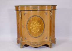 A French style tulipwood serpentine fronted cabinet with marquetry inlaid decoration and brass