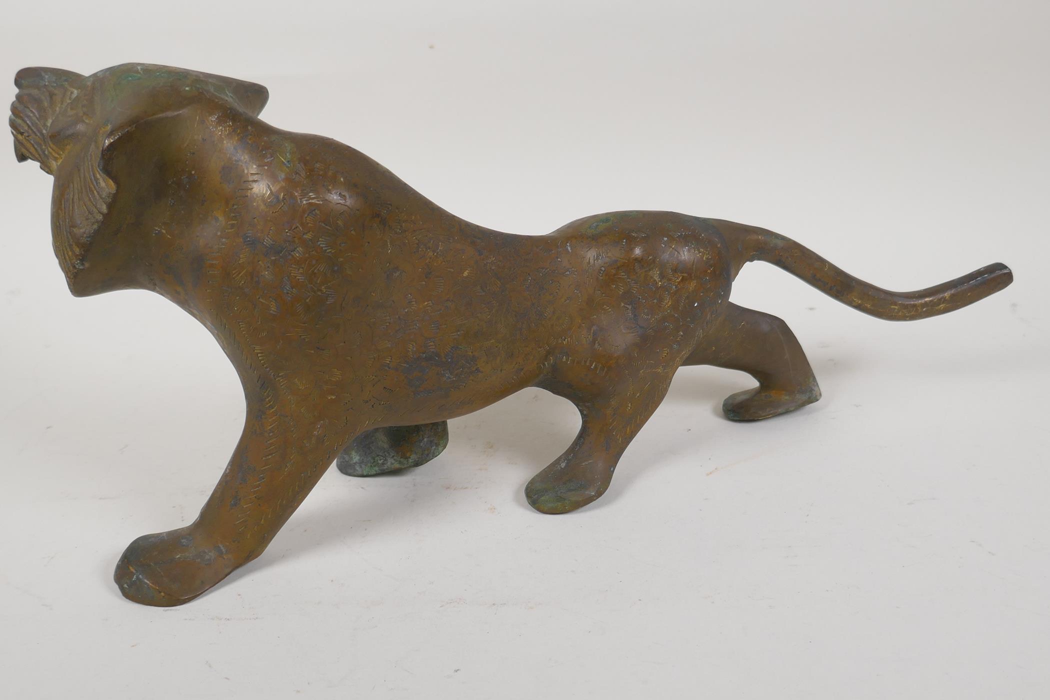 An Eastern stylised yellow metal figure of a lion, 15" long - Image 4 of 6