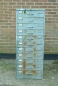 An industrial painted metal workshop cabinet with eleven partitioned drawers, 20" x 25", 52" high