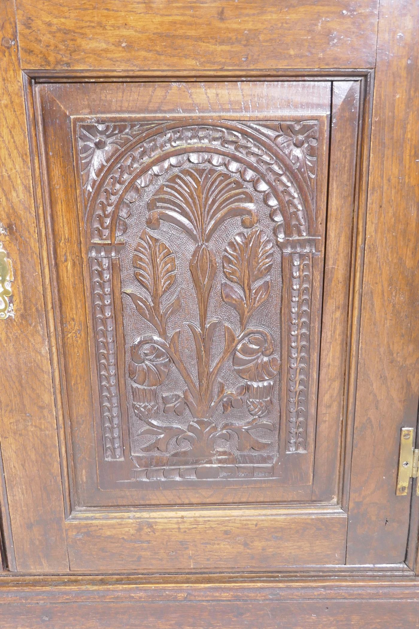 An antique oak corner cabinet with two glazed doors over two doors with carved panels, adapted, - Image 3 of 5