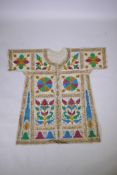 An Islamic linen robe with all over hand painted calligraphy decoration 41" long